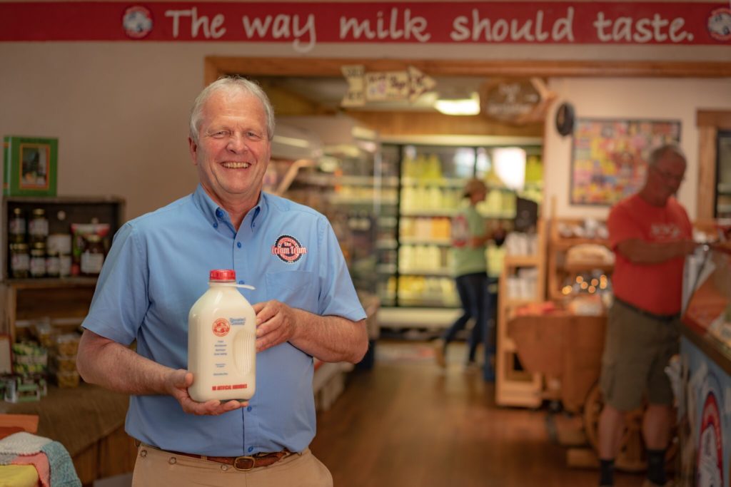 Donnie Montgomery holding a half gallon of whole milk